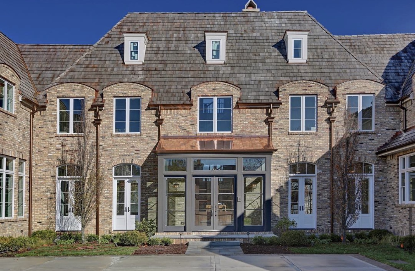 Limestone home with a formal symmetrical facade